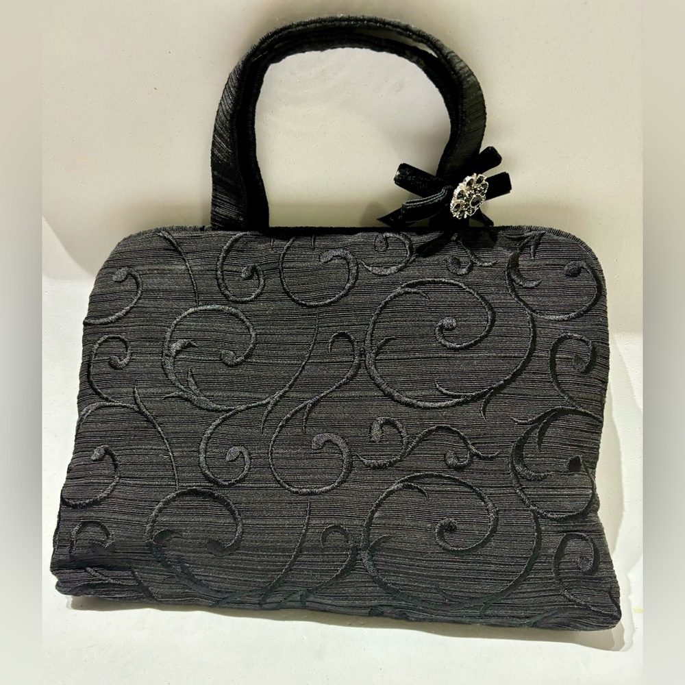 Oscar by Oscar dela Renta Elegant Black Toiletries Handbag with Floral Accent